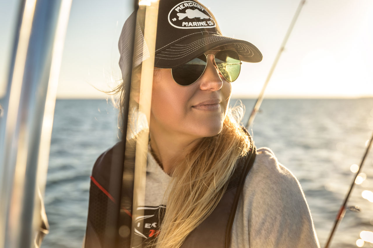 Woman in sunglasses wearing Mercury Marine hat